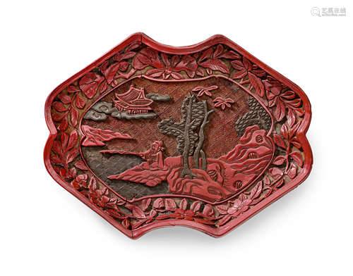 A Ming carved cinnabar and green lacquer ingot-shaped tray