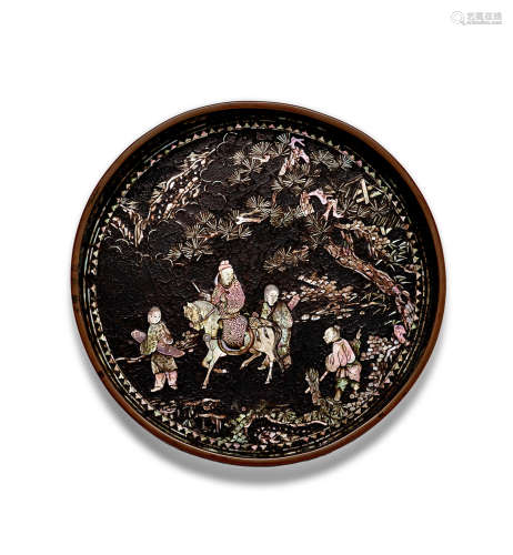 A mother-of-pearl-inlaid black lacquer circular straight-sid...