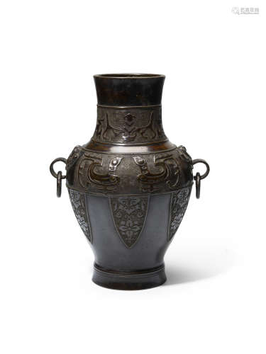 An archaistic patinated bronze baluster vase