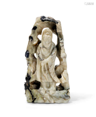 A cream and black nephrite jade figure of Guanyin