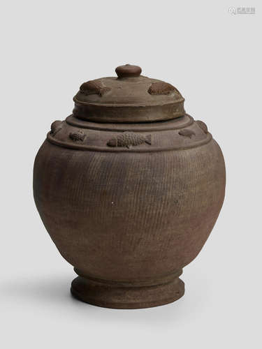 A BROWN LIDDED STONEWARE JAR WITH APPLIED FISH DECORATION