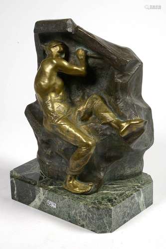 "Le mineur" en bronze à patine brune et dorée. Sig...