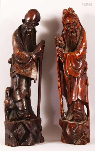 TWO CHINESE CARVED HARDWOOD FIGURES - one inlaid with silver...