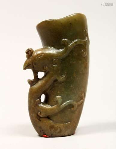 A CHINESE CARVED JADE LIBATION CUP, 5ins high.