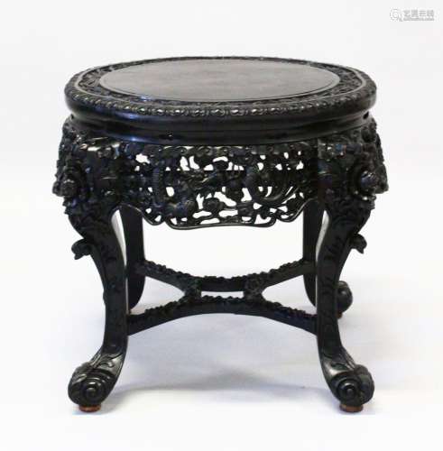 A SUPERB CHINESE CARVED EBONY STAND, the top border carved w...