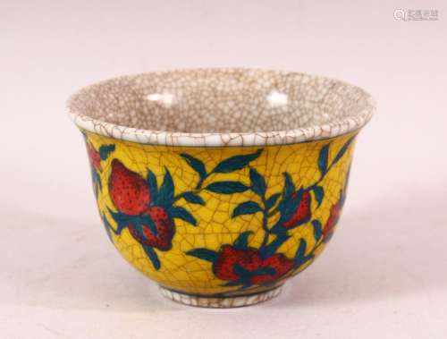 A YELLOW GROUND CRACKLE GLAZE TEA BOWL, decorated with peach...