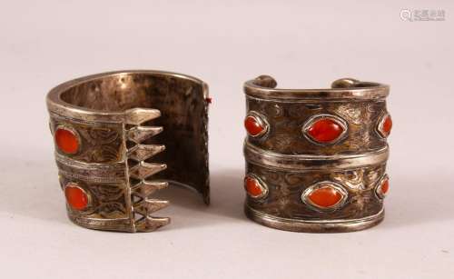 TWO ISLAMIC SILVER BANGLES, inset with stones - possibly amb...