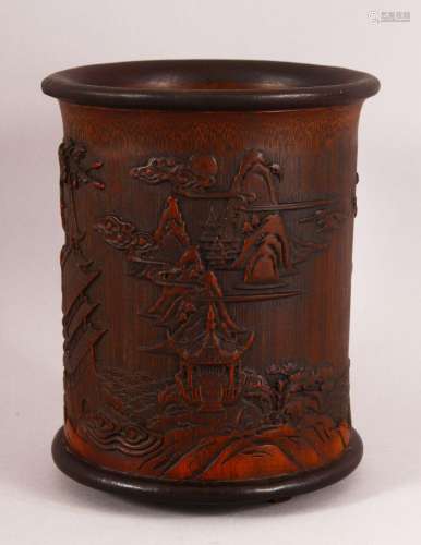 A CHINESE BAMBOO CARVED BRUSH POT - decorated with village l...