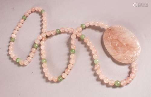 A CHINESE ROSE QUARTZ CARVED NECKLACE / PENDANT - with a car...