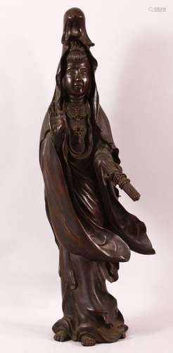 A CHINESE BRONZE FIGURE OF GUANYIN holding a scroll, her oth...