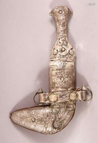 A SMALL ISLAMIC DAGGER, possibly low grade silver, and sheat...