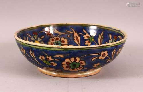 A DECORATIVE IZNIK STYLE POTTERY BOWL, painted with flowers ...