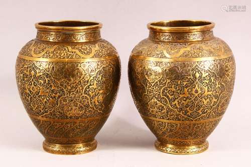 A PAIR OF PERSIAN BRASS VASES, with profusely engraved and c...