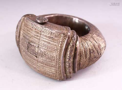A PERSIAN WHITE METAL SLAVE BANGLE, with engraved and emboss...