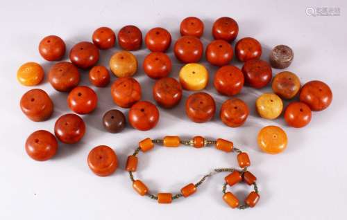 A LARGE LOT OF BAKELITE OR CHERRY AMBER STYLE CARVED BEADS, ...