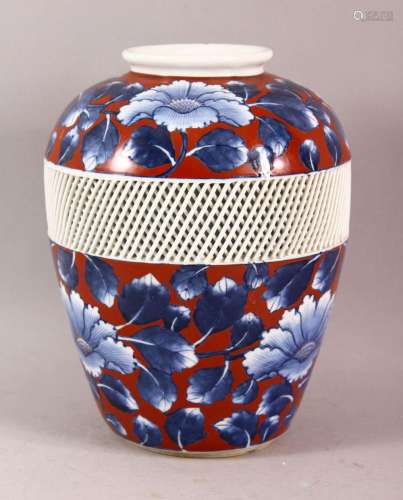 A JAPANESE BLUE AND RED PORCELAIN VASE, the body with a reti...