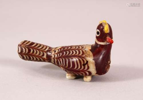 AN EARLY ISLAMIC MARVERED GLASS MODEL OF A BIRD, 7cm long.