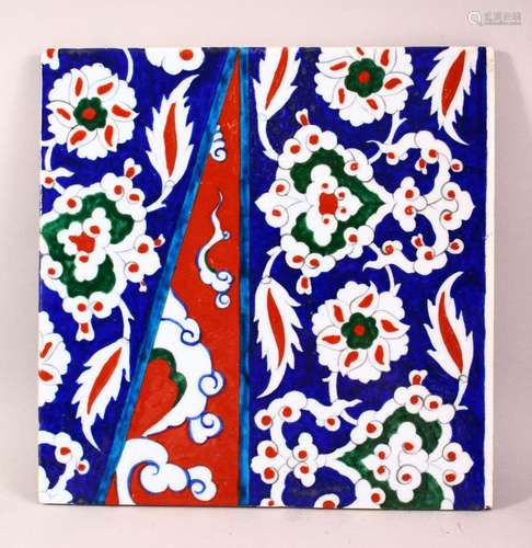 A TURKISH IZNIK STYLE POTTERY TILE - decorated with floral m...