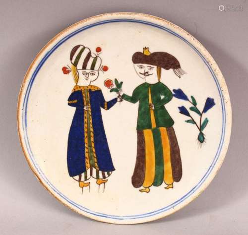 A TURKISH KUTAHYA POTTERY FIGURAL PLATE - decorated with fig...