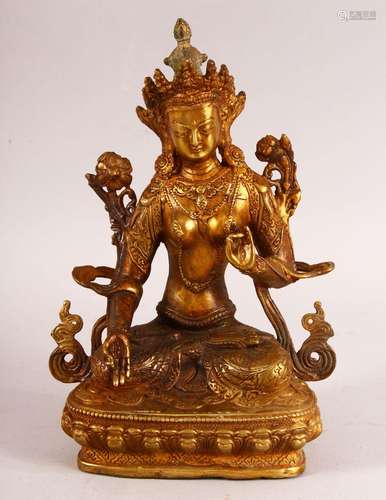 A CHINESE TIBETAN GILT BRONZE FIGURE OF A DEITY - in a seate...