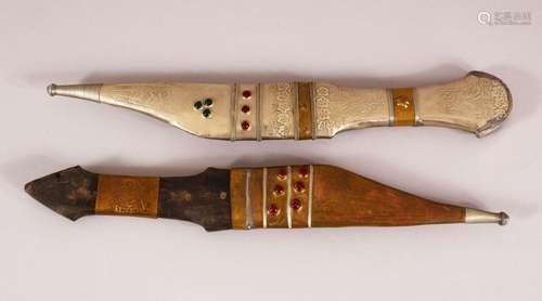 TWO ISLAMIC WHITE METAL AND INLAID DAGGERS -- each inlaid wi...