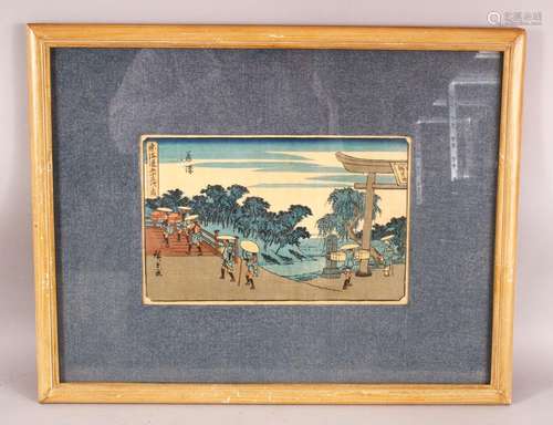 A JAPANESE FRAMED WOOD BLOCK PRINT - depicting figures walki...