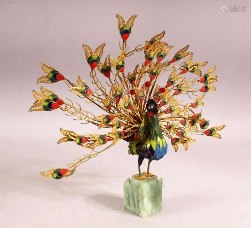 A DECORATIVE GILT METAL AND ENAMELLED MODEL OF A PEACOCK, pl...