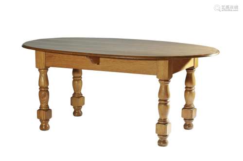 AN OVAL OAK DINING TABLE IN THE MANNER OF LUTYENS