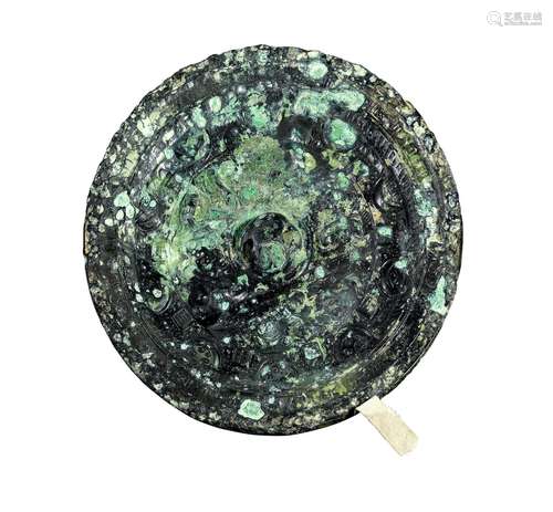 A CHINESE ARCHAIC BRONZE MIRROR EASTERN HAN DYNASTY (25-220)...