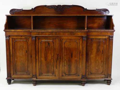 A Regency rosewood breakfront four-door bookcase, having a r...