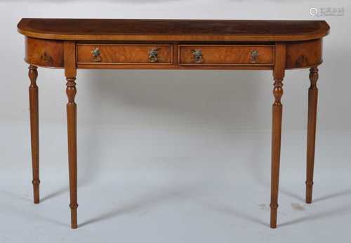 A walnut and figured walnut D-end hall table, having a cross...