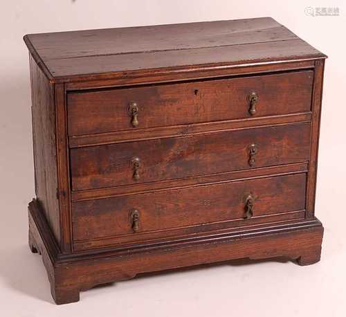 An antique oak chest, of small proportions, having a two pla...