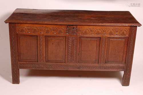 A circa 1700 joined oak four-panel coffer, the two plank top...