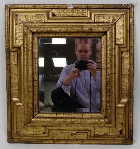 An 18th-century giltwood and gesso wall mirror, having raise...