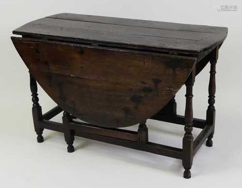 A circa 1700 joined oak gateleg table, having oval fall leav...