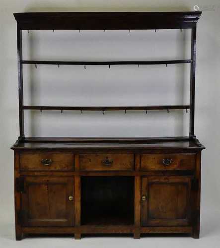 A George III joined oak dresser, the three-tier plate rack h...