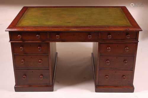 A Victorian oak twin pedestal desk, having a gilt tooled lea...