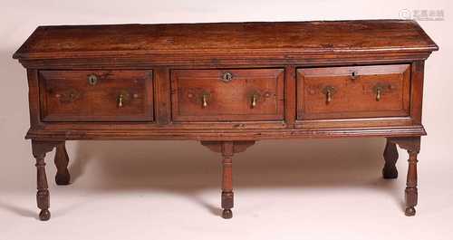 An 18th century oak and fruitwood dresser base, the two plan...