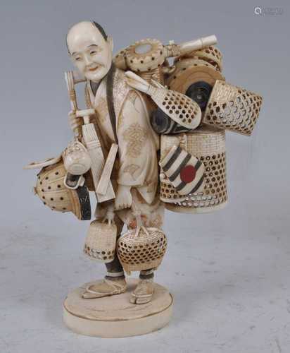 A Japanese Meiji period carved ivory okimono of a basket sel...