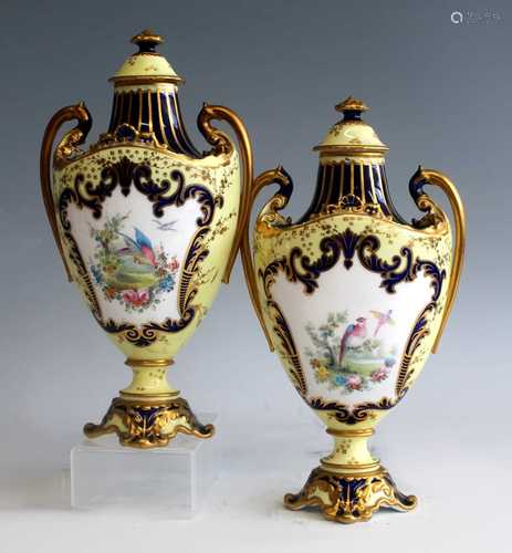 A pair of circa 1900 Royal Crown Derby pedestal urns with co...