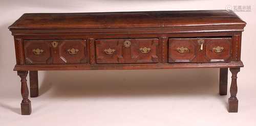 An early 18th century oak dresser base, having a two plank t...