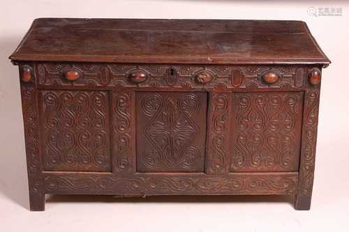 A late 17th century joined oak coffer, having a planked top ...