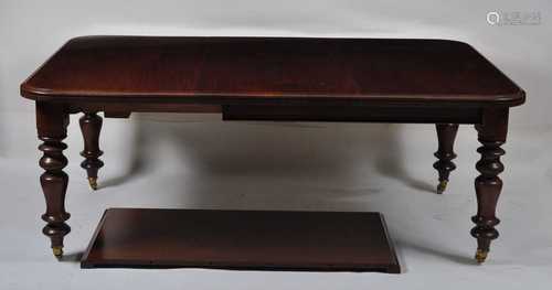 A Victorian mahogany extending dining table, the top having ...