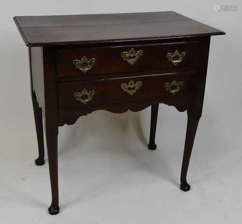 A George III oak side table, having a two-plank top with mou...