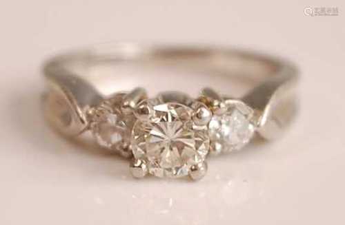 A white metal diamond three-stone ring, featuring three grad...