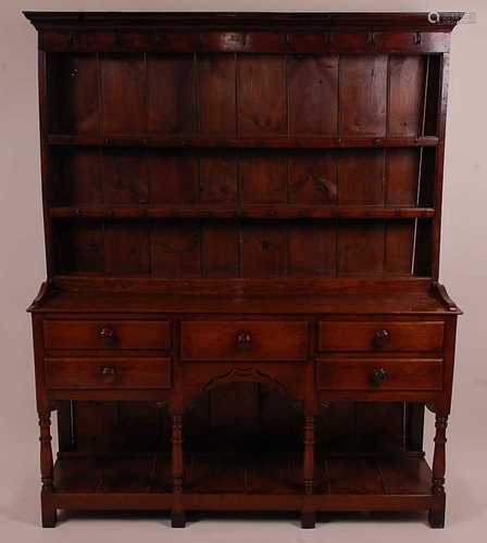 An 18th century oak dresser, the upper section having a two-...