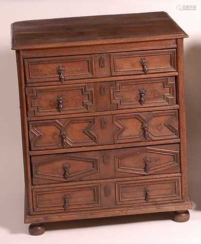 A Jacobean period oak chest, of five long geometric moulded ...