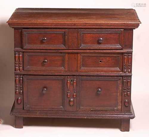 A Jacobean period oak chest of three long geometric moulded ...