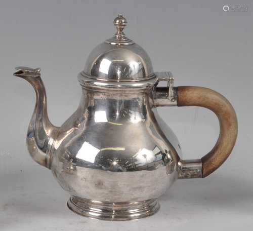 A George V Britannia silver teapot, the plain body of typica...