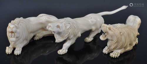 A pair of 19th century Indian carved ivory lions, each in ro...